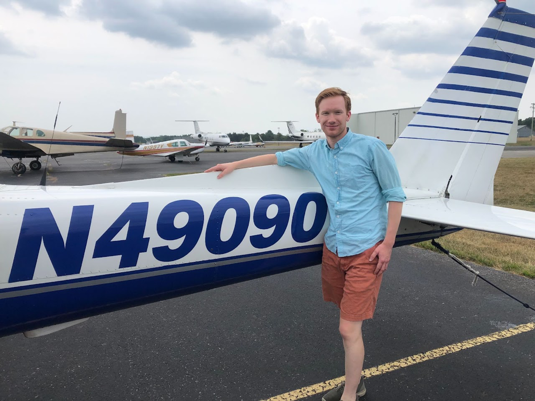 Christopher Aselin standing beside an aircraft