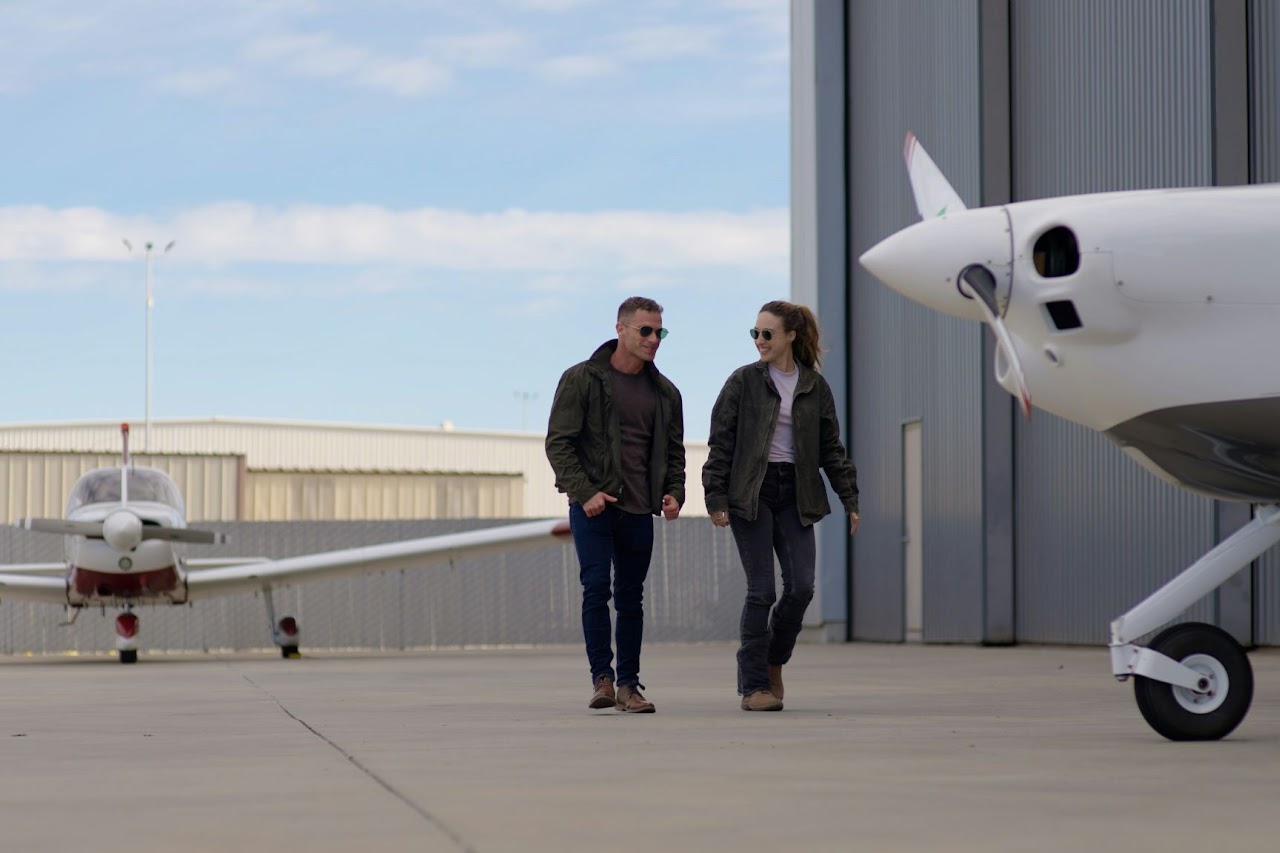 Group standing by an aircraft