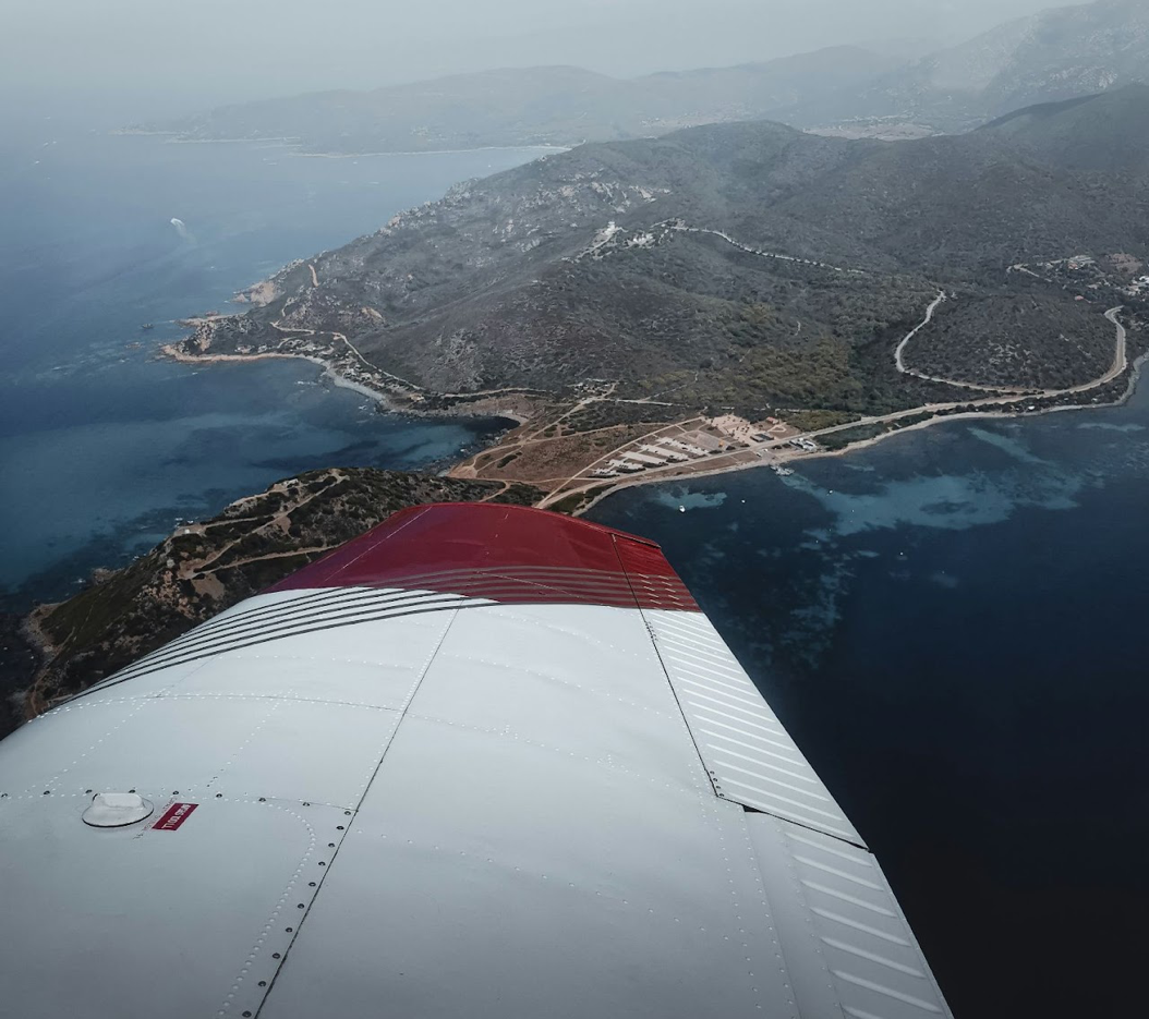 Aircraft wing over coastline